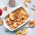 Apple chips with cinnamon that are baked until crispy in a ceramic dish.