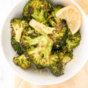 Baked broccoli with garlic and lemon in a bowl.