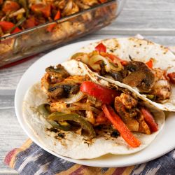 Baked chicken fajitas served in flour tortillas with chicken breast, bell peppers, and red onions. 