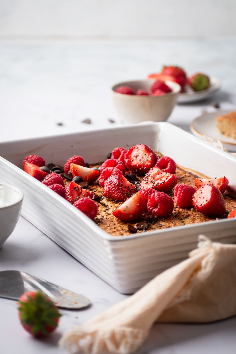 Easy baked rolled oatmeal with chia seeds, flax seeds, berries, and chocolate.