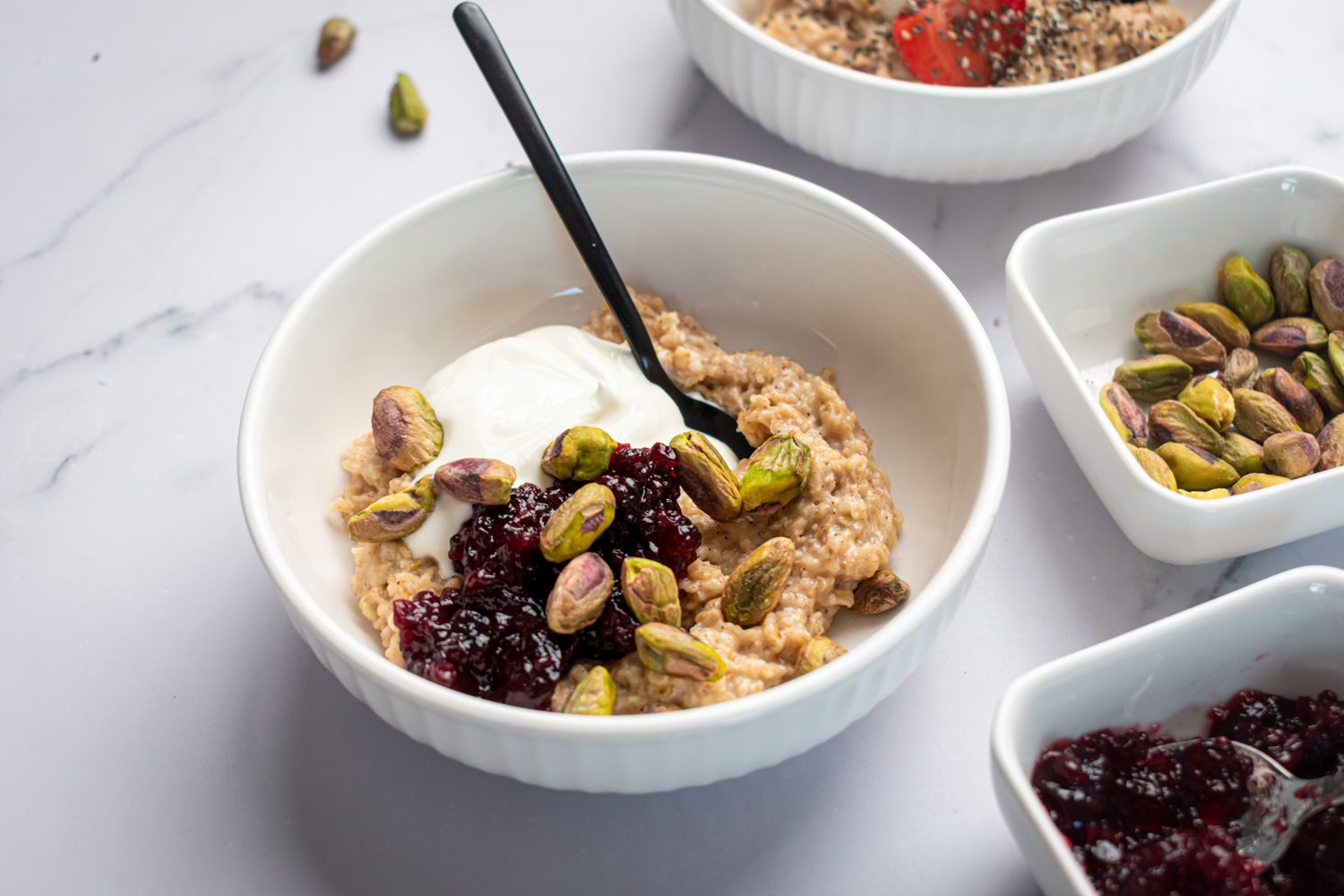 Easy microwave oatmeal cooked with rolled oats and milk served with fresh fruit, nuts, and yogurt.