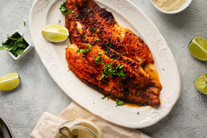 Blackened mahi mahi served with homemade blackening seasoning on a plate with fresh lime wedges.