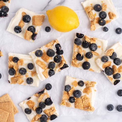 Blueberry Lemon Frozen Yogurt Bark with Graham Crackers on a White Board