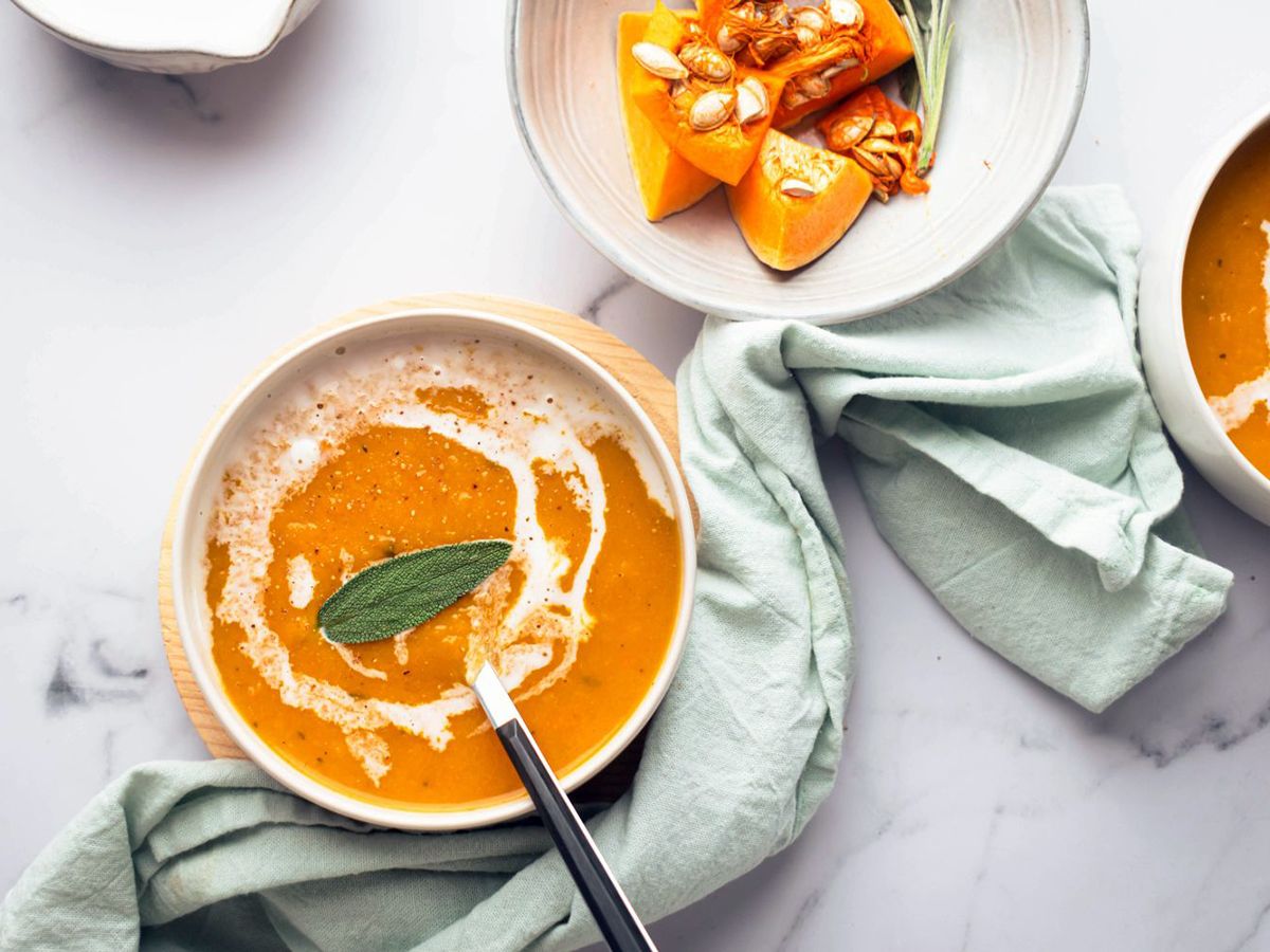 Two Bowls of Butternut Squash Soup Garnished With a Sage Leaf