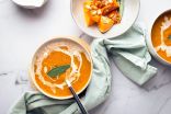 Two Bowls of Butternut Squash Soup Garnished With a Sage Leaf