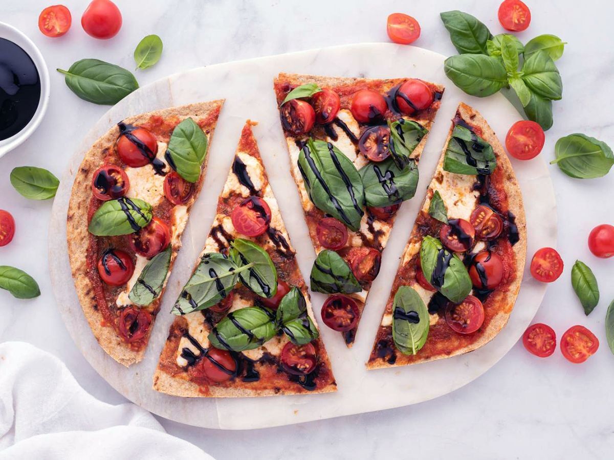 Caprese Flatbead With Cherry Tomatoes, Fresh Mozzarella, Basil Leaves, and Balsamic Vinegar