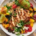 Chicken quinoa bowls with sliced grilled chicken, pico de gallo, cilantro, lime, and chili lime dressing.