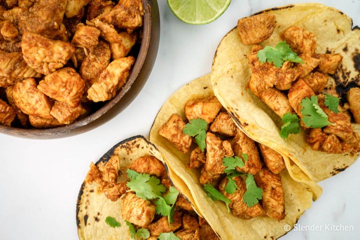 Chicken soft tacos with seasoned chicken breast and cilantro served on corn tortillas. 