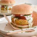 Ranch chickpea burgers served on a bun with lettuce, tomato, and ranch dressing. 