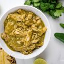 Authentic chile verde made with chicken in a green salsa in a bowl with cilantro.