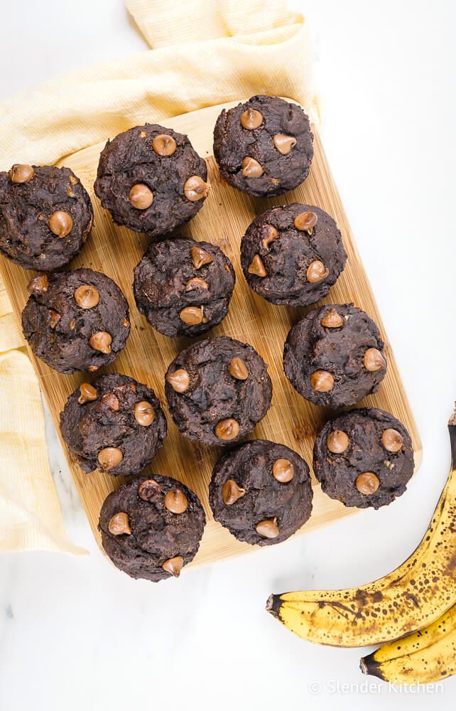 Muffins with chocolate and bananas with chocolate chips on a wooden board.