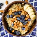 Cinnamon quinoa breakfast bowl  in a wooden bowl with blueberries and almonds.