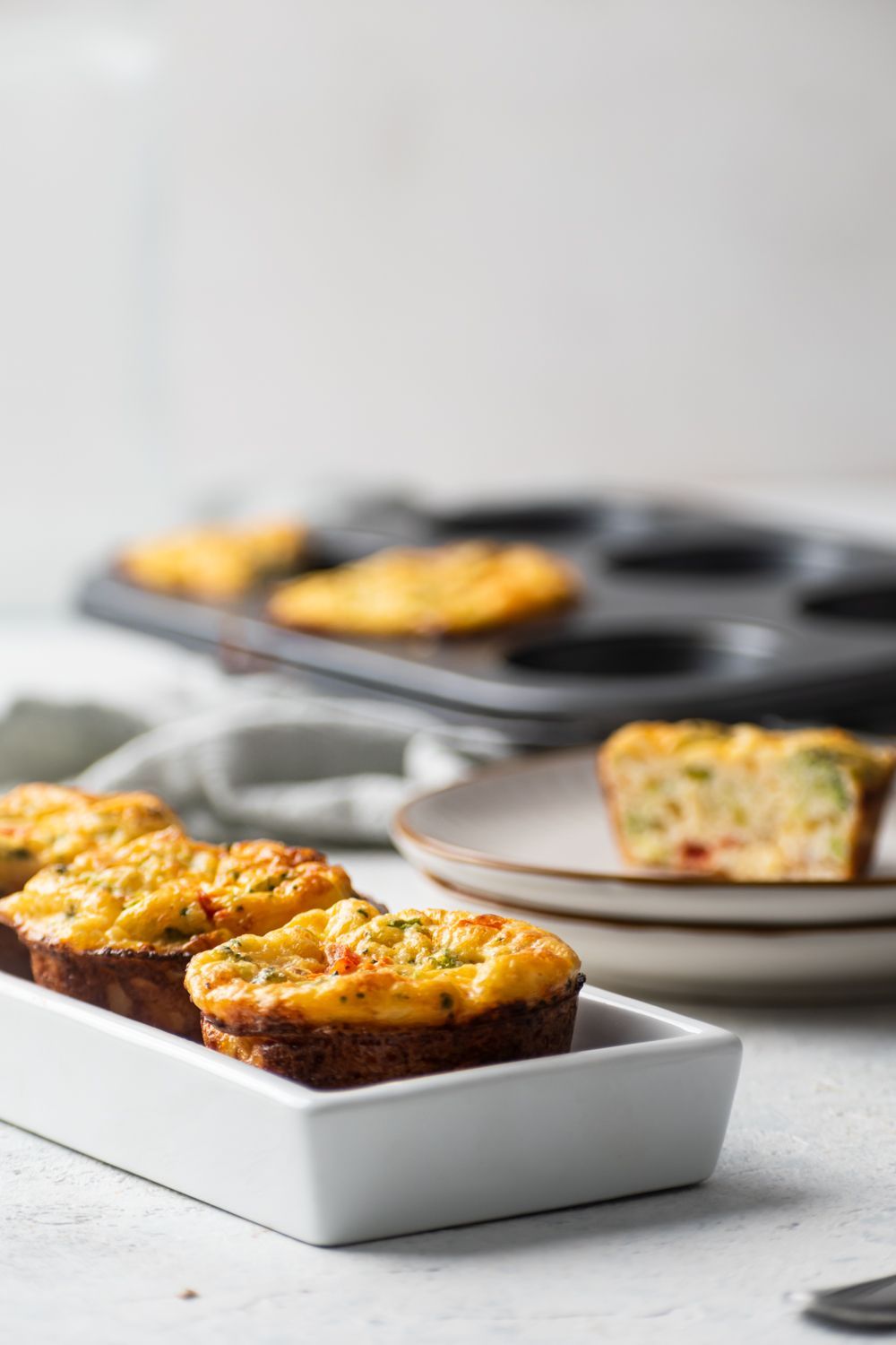 Baked cottage cheese, egg, and vegetable muffins with broccoli, red peppers, and cheddar cheese.