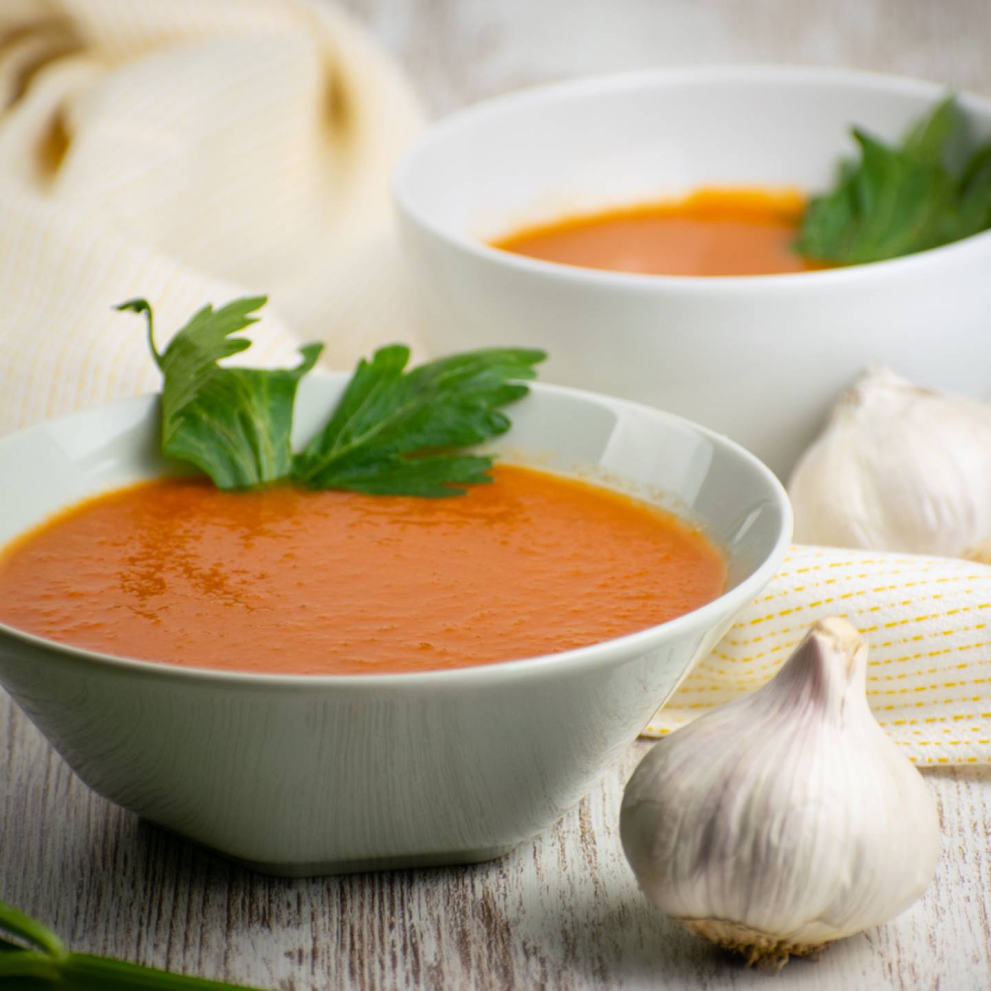 Slow cooker tomato soup with chipotle flavors in a bowl with a napkin.