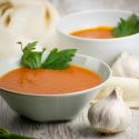 Slow cooker tomato soup with chipotle flavors in a bowl with a napkin.