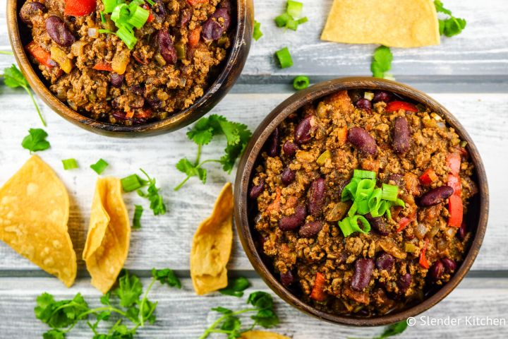 Healthy Turkey chili in two bowls with cilantro and tortilla chips.