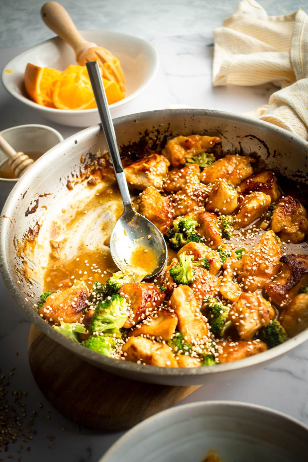 Healthy orange chicken and broccoli in a homemade orange stir fry sauce with sesame seeds.