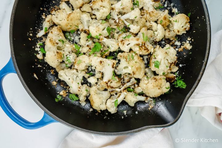 Garlic Parmesan Roasted Cauliflower in a skillet with fresh parsley.