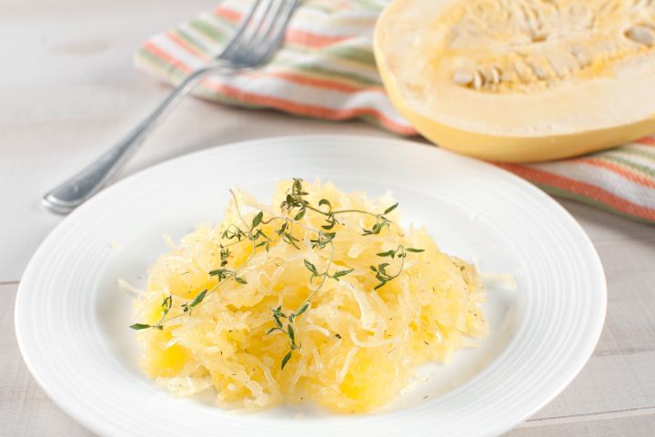 Garlic spaghetti squash on a plate with parsley.