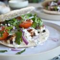 Grilled chicken souvlaki marinated in lemon and garlic served in a pita with tzatziki, tomatoes, red onions, and parsley.