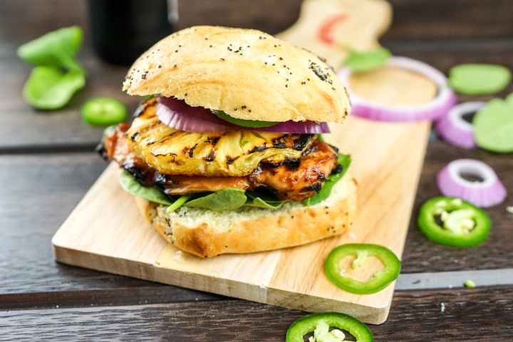 Hawaiian Chicken Sandwiches with pineapple slices and chicken breast on a bun.