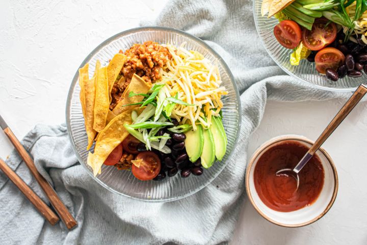 Turkey taco salad with ground turkey, tomatoes, black beans, cheddar cheese, and crispy tortilla strips.