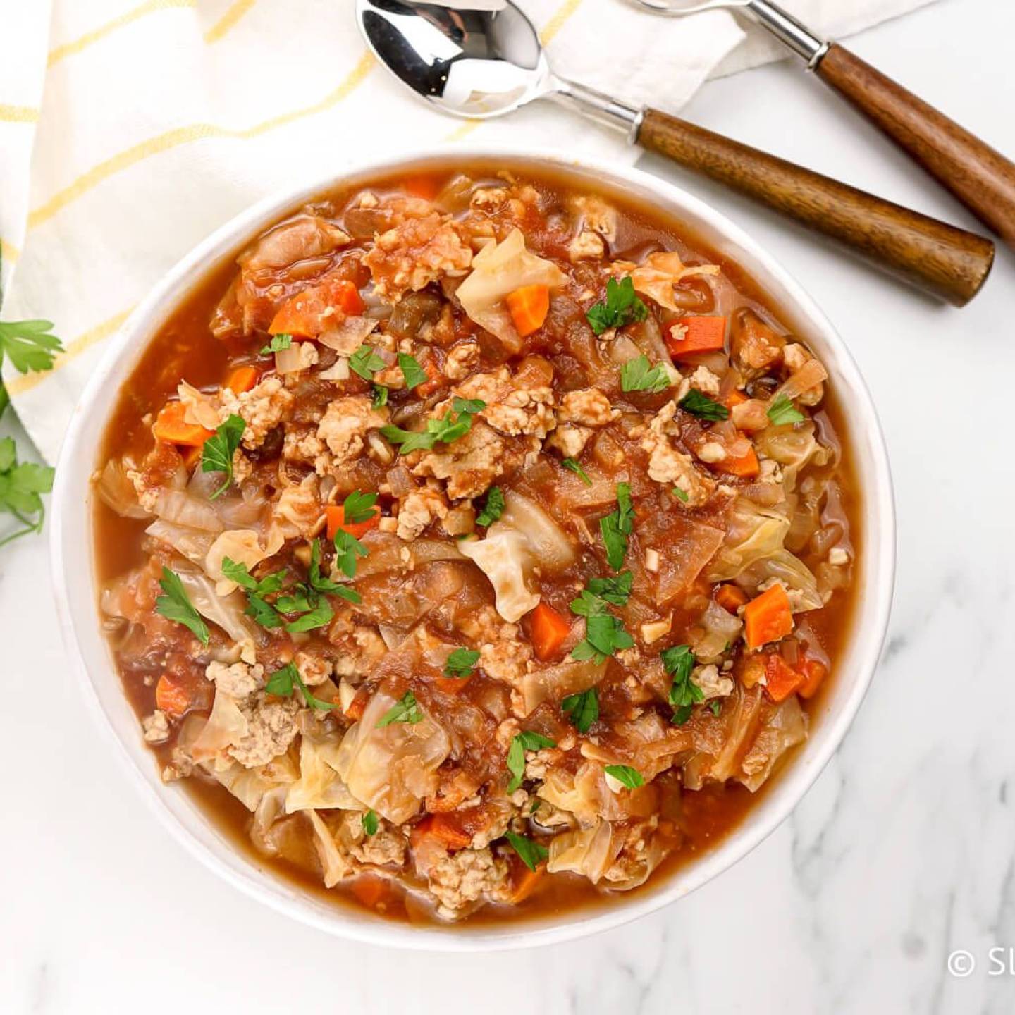 Healthy cabbage soup with cabbage, ground turkey, tomatoes, and cauliflower rice in a bowl.