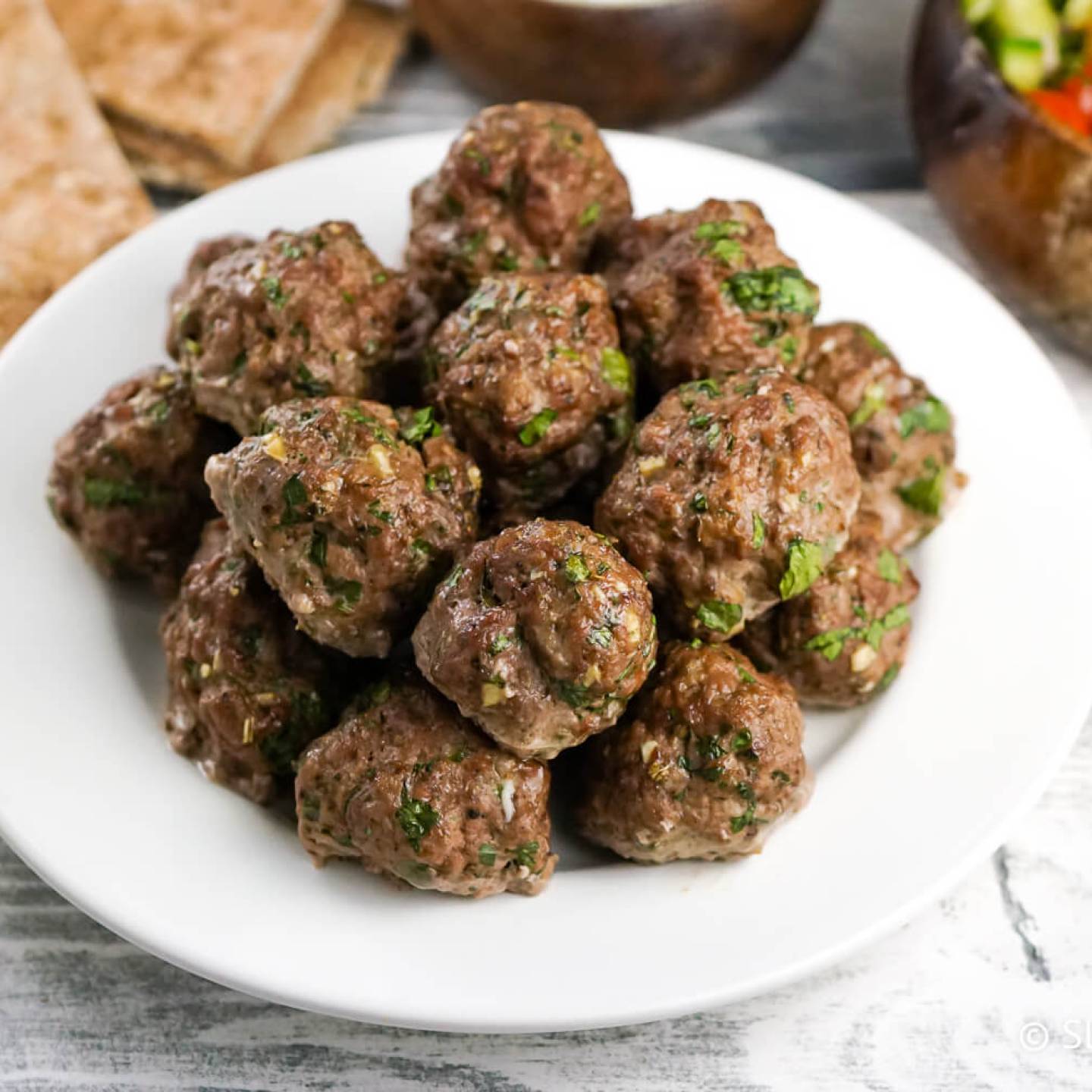 Greek meatballs or Keftedes with cucumber salad and tzatziki.