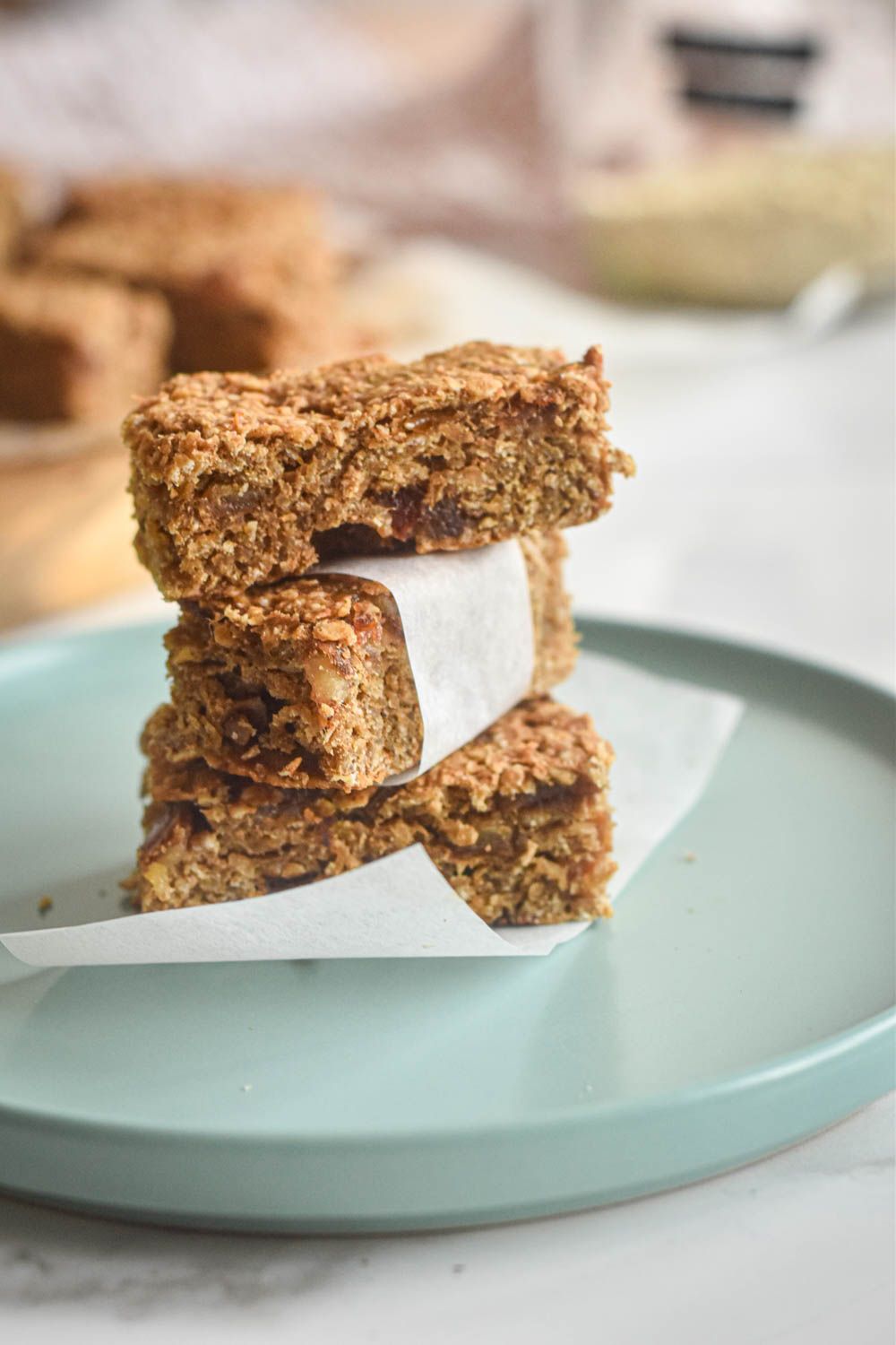 Healthy oat bars made with bananas, oatmeal, peanut butter, and dates sliced into bars and stacked.