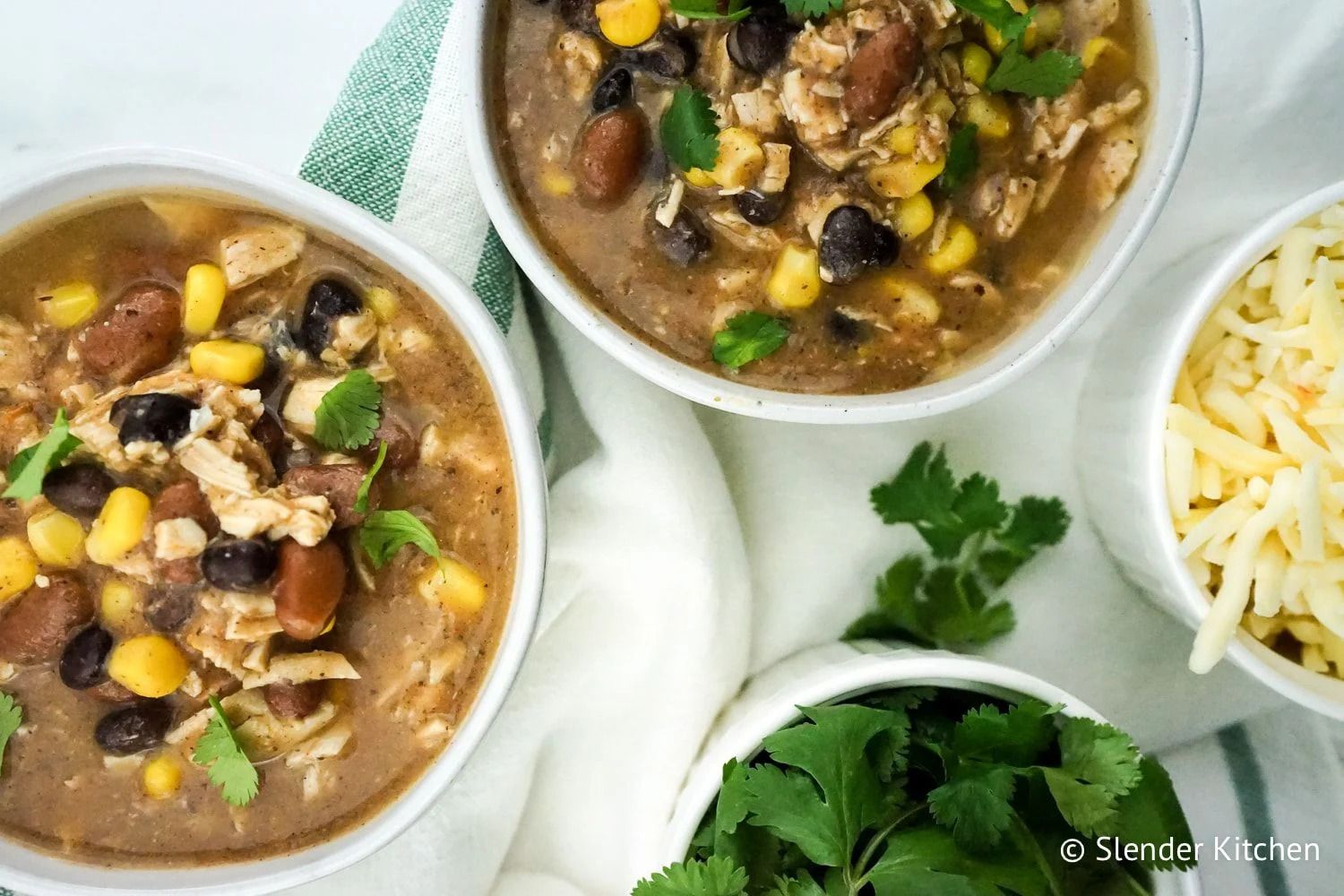 Make ahead healthy taco soup with beans, corn, chicken, and tomatoes.