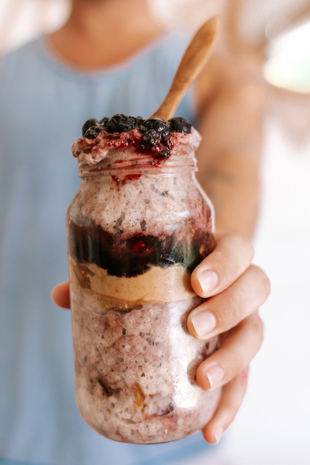 Overnight oatmeal in a jar with rolled oats, blueberries, almond milk, and chia seeds.