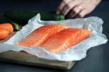 Salmon meat on brown chopping board