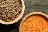 Two bowls with peeled and unpeeled red lentils