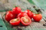 Fresh, ripe cherry tomatoes on a wood table