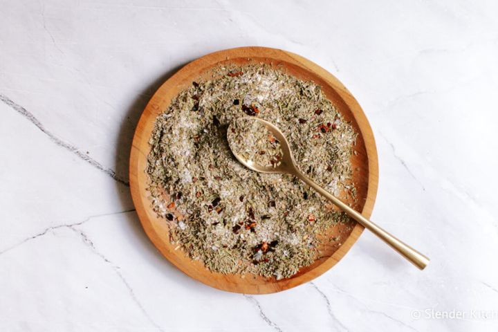 Italian seasoning mixed on a plate with oregano, basil, rosemary, thyme, garlic powder, and red pepper flakes. 