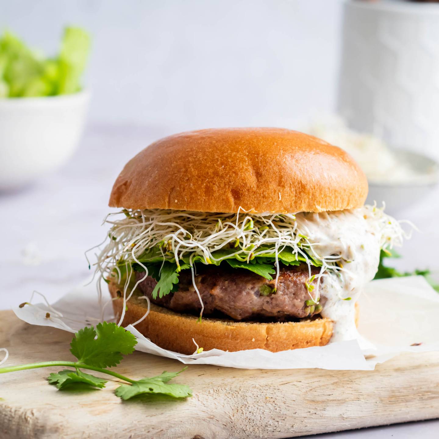 Jalapeno cheddar burgers with lettuce, tomato, and onion served on a hamburger bun, 