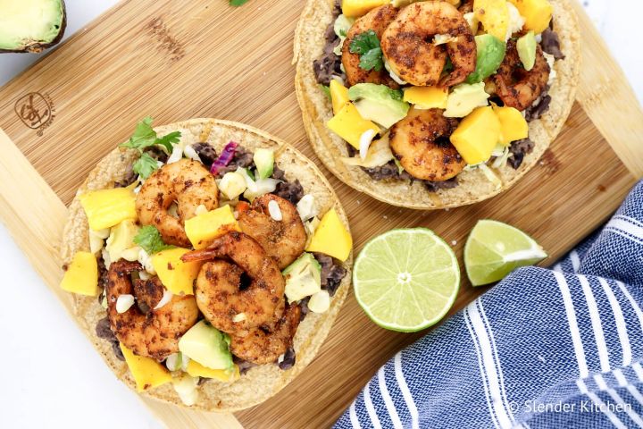 Shrimp Mango Tostadas with black beans, cabbage, corn, mango, cilantro, and avocado.