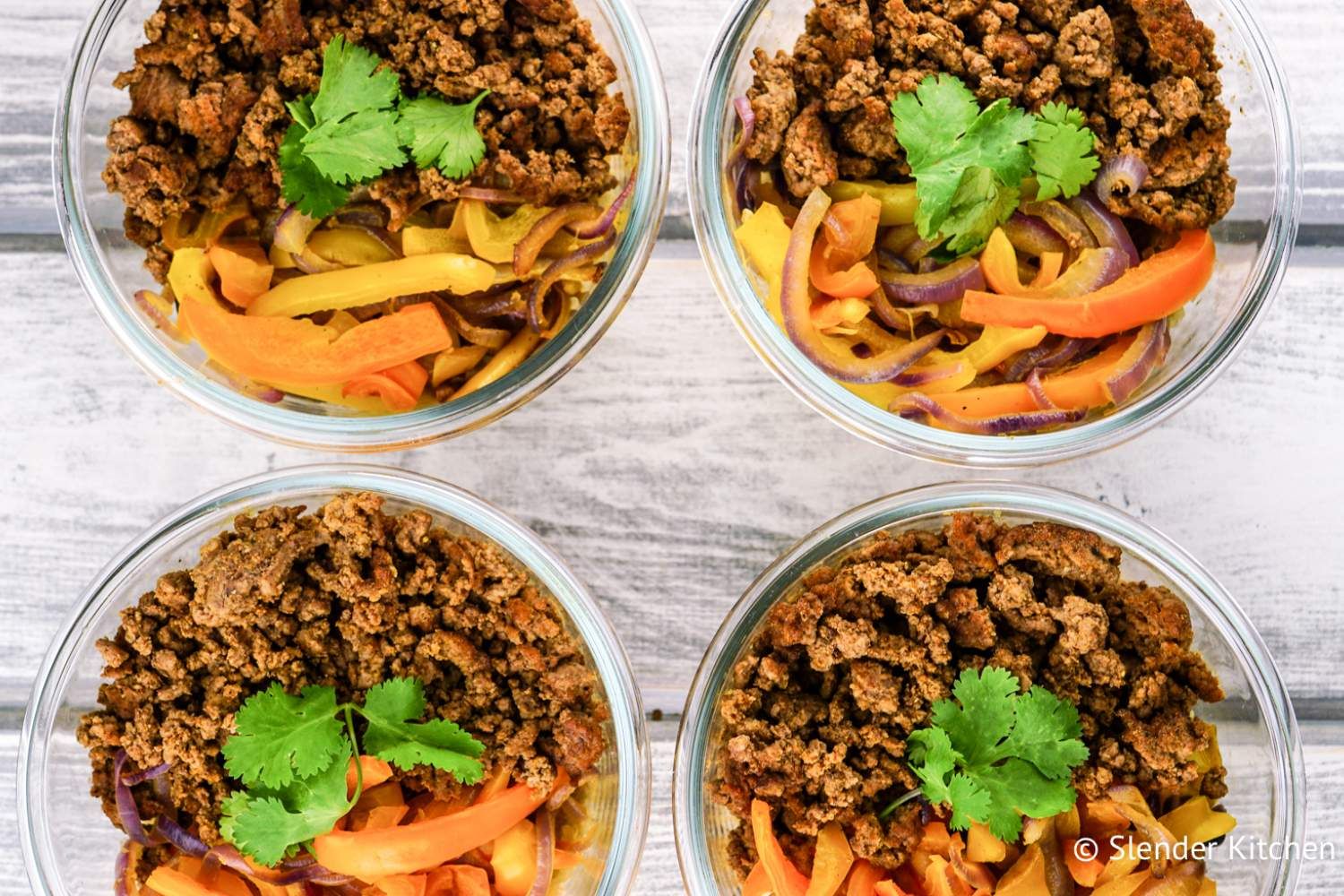 Meal Prep Taco Bowls with peppers, onions, and cauliflower rice.