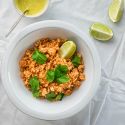 Mexican cauliflower rice with fresh cilantro, limes, and salsa on the side.