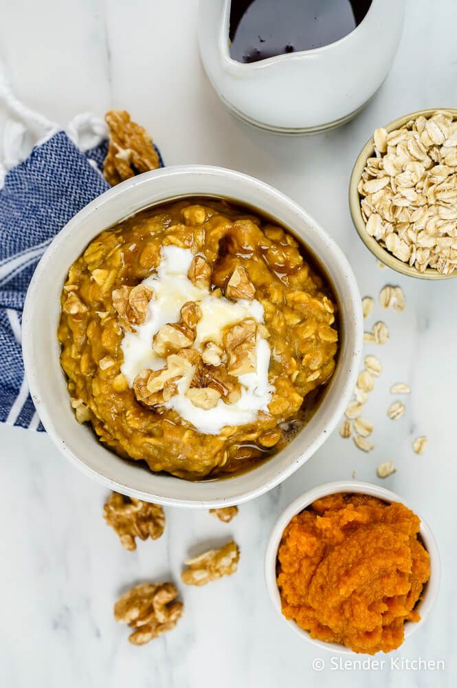 Microwave pumpkin oatmeal with chopped walnuts and maple syrup in a bowl.