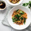 Moo shu vegetables with eggs and hoisin sauce served in a bowl with cabbage, broccoli, and mushrooms.