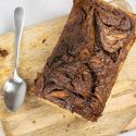 Nutella banana bread with swirls of nutella and banana on a wooden cutting board.