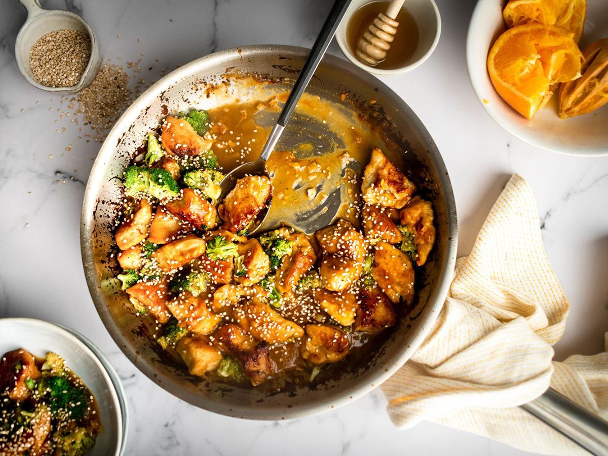 Orange Chicken With Broccoli Served in a Skillet With Sticky Sauce and Sesame Seeds