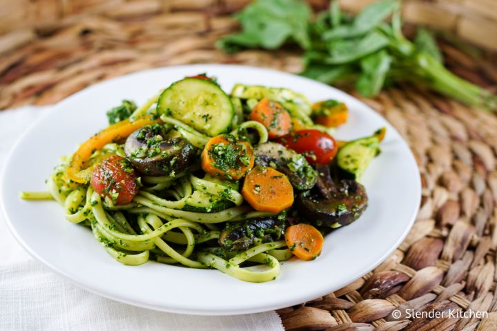 Pesto pasta primavera with cooked veggies, pesto, and linguini with fresh basil on the side. 