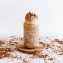 Chocolate peanut butter overnight oats in a glass jar with peanut butter and cocoa powder.