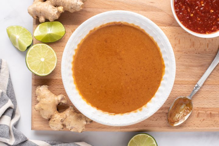 Peanut sauce made with peanut butter, soy sauce, maple syrup, ginger, hot sauce, and rice vinegar in a small bowl.