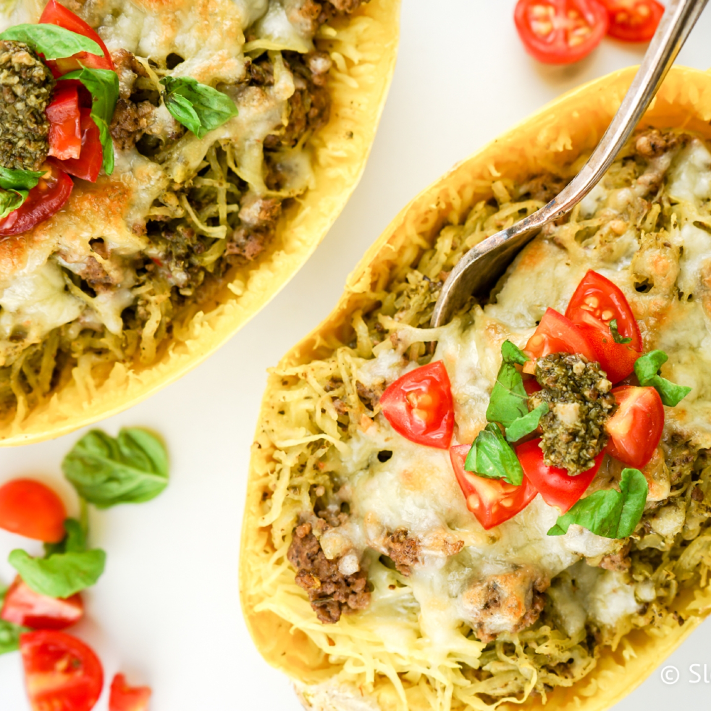 Pesto spaghetti squash with melted cheese, turkey sausage, and diced tomatoes.