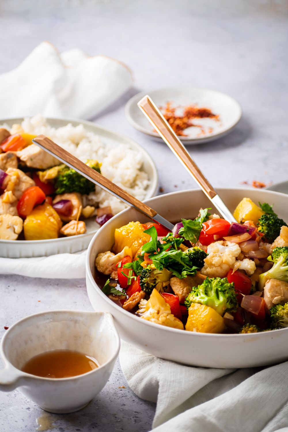 Chicken breast, pineapple. and vegetable stir fry with fresh pineapple and stir fry sauce in a bowl and served with rice.