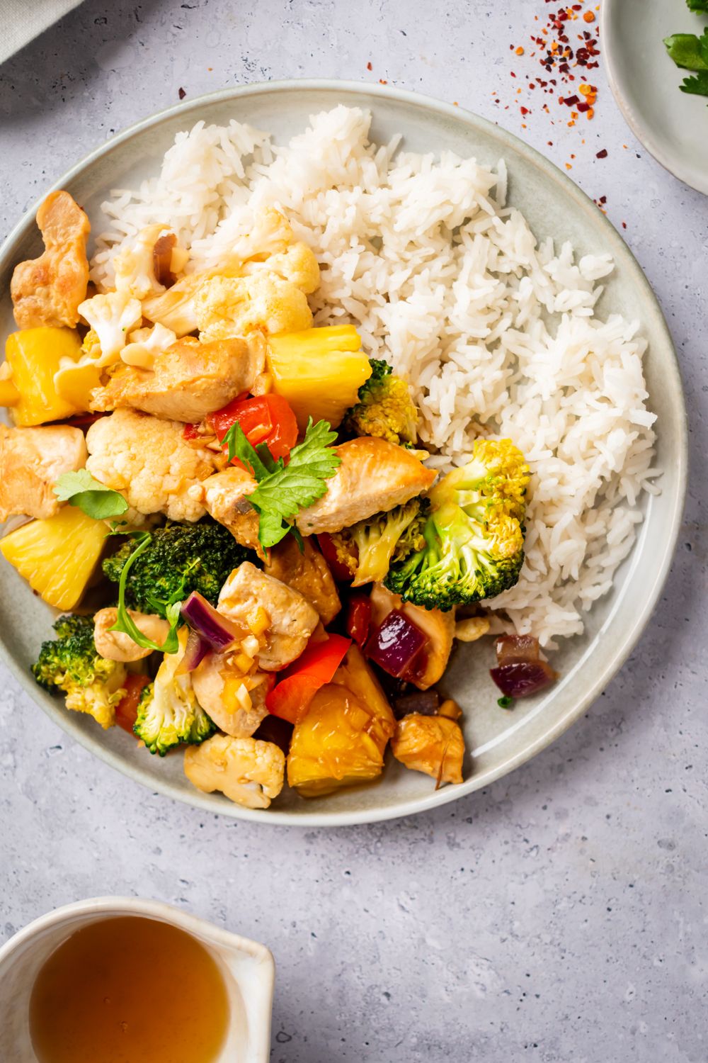 Pineapple, chicken breast, and vegetable stir fry served with white rice and extra stir fry sauce.