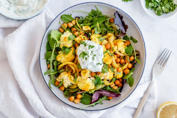 Roasted cauliflower and chickpeas on pita bread with yogurt sauce.